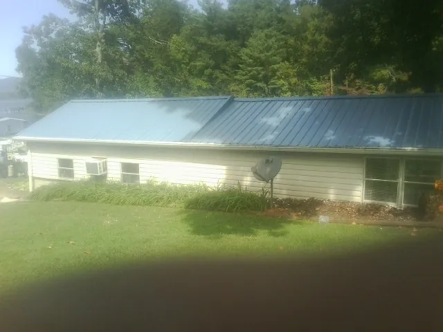 Blue metal roof running the length of a single story home in Porterdale