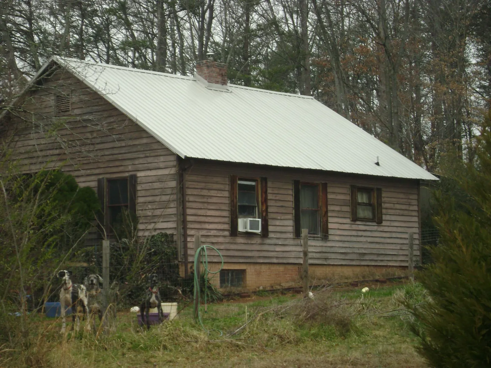 White metal roof on an old wood sided farmhouse, from a Metal Roof Installation job in Porterdale